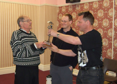 Peter receiving a statuette of himself from Tony Baker and Ash Burrows, when he stood down as President in 2009 ~ by PCW